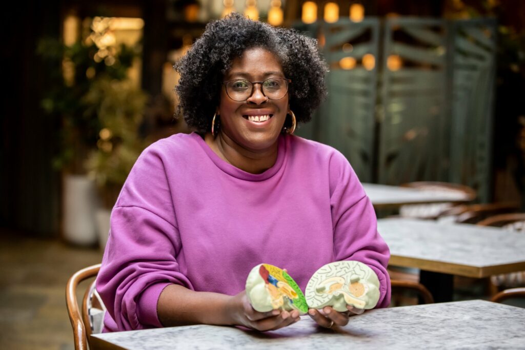 Woman holding prop takes business branding photo in Hertfordshire