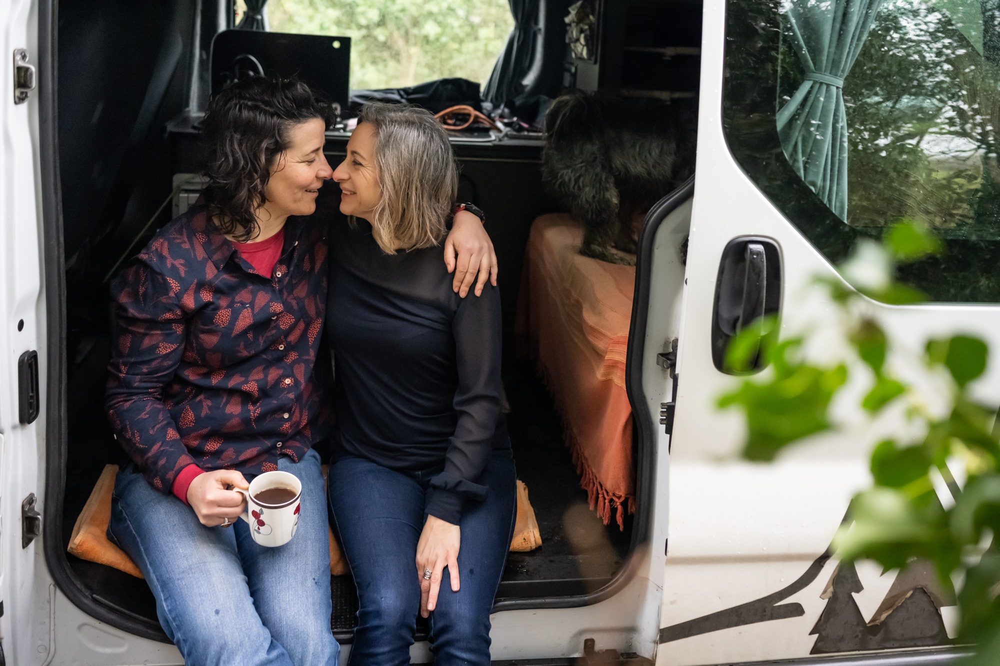 Same sex couple hug in their camper van on a Hertfordshire engagement shoot