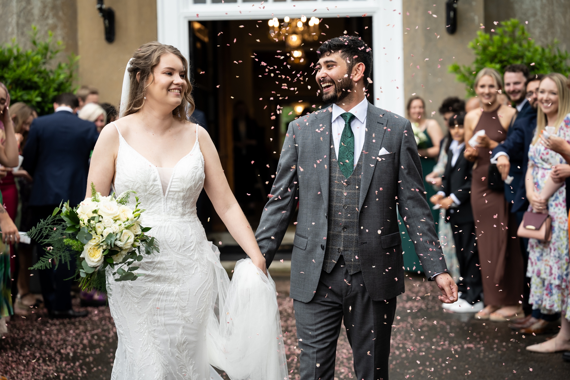 Bride and groom exit Offley Place to confetti throw