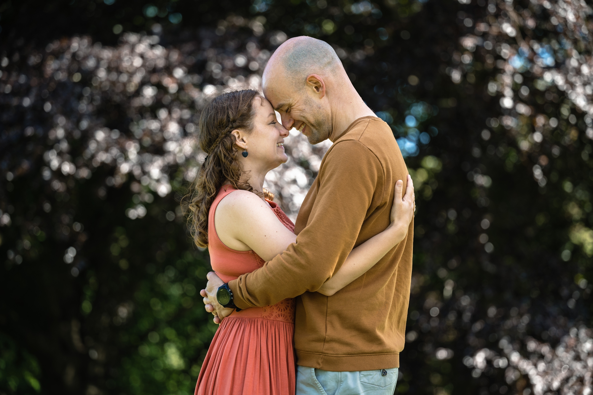 Quiet moment on autumn engagement shoot in front of autumnal trees in Hertfordshire