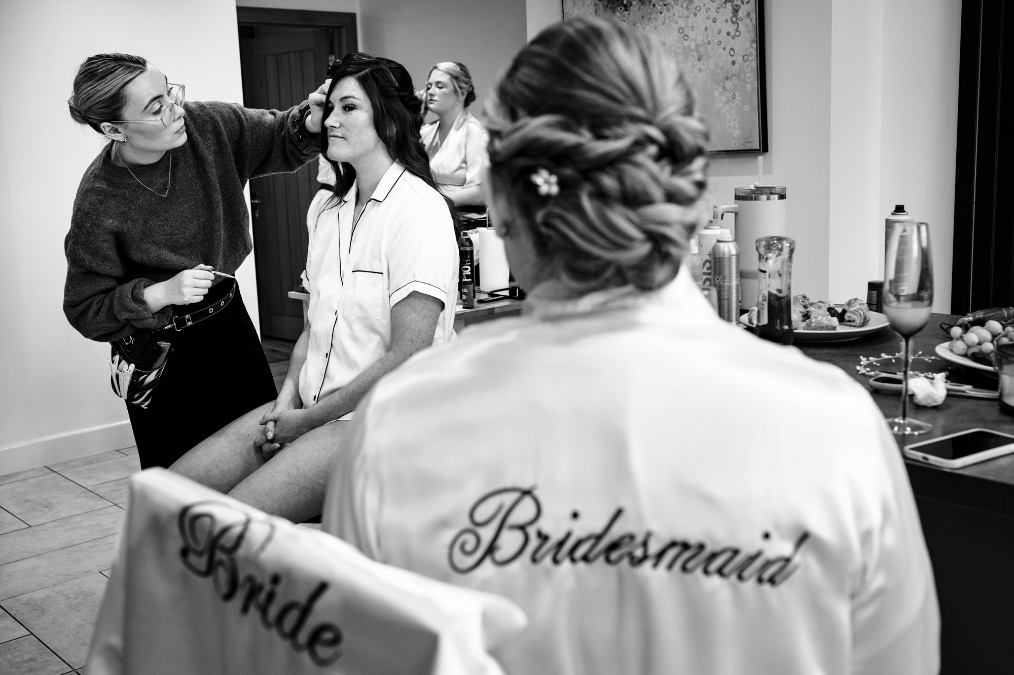 Bride gets makeup done with bridesmaids