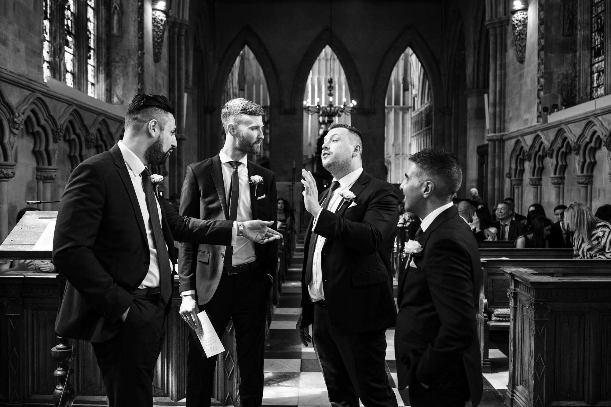 Groom and groomsmen chat at top of aisle just before ceremony