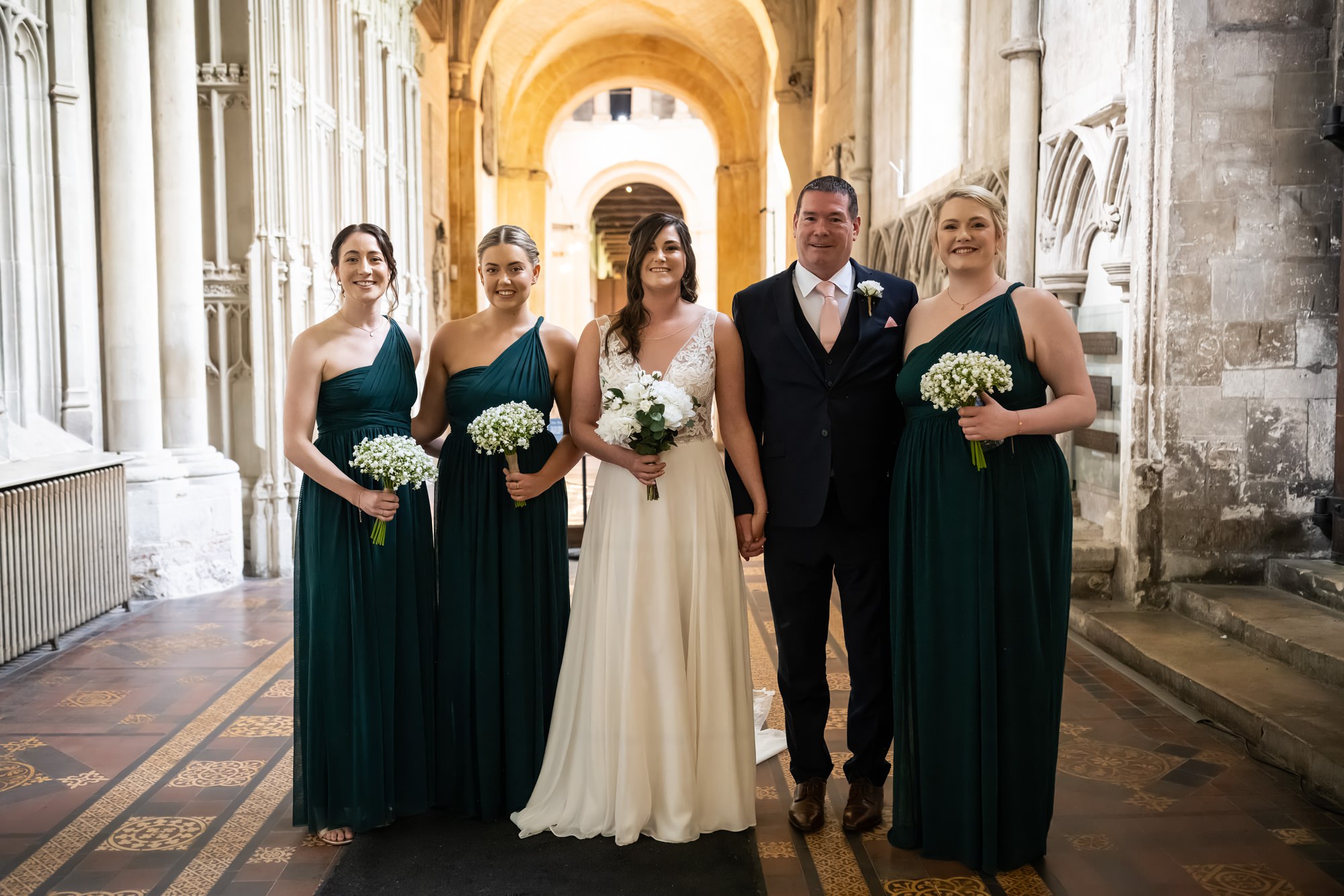 Bride, dad and bridesmaids in St Albans cathedral just before walking down aisle