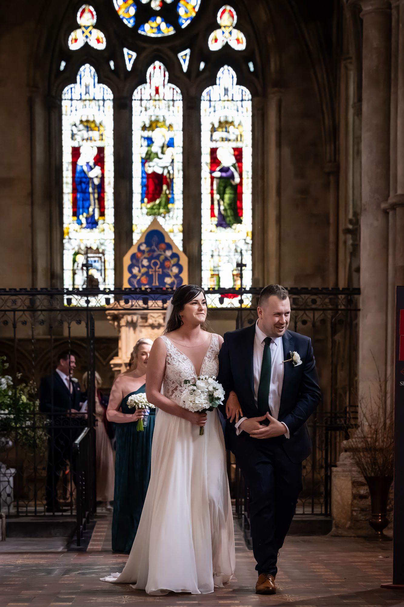 Bride and groom walk down St Albans cathedral aisle after wedding ceremony