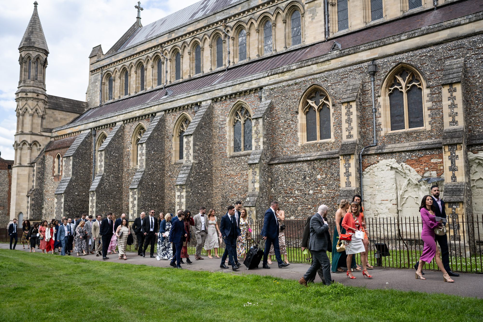 Guests walk from St Albans cathedral to pub wedding reception