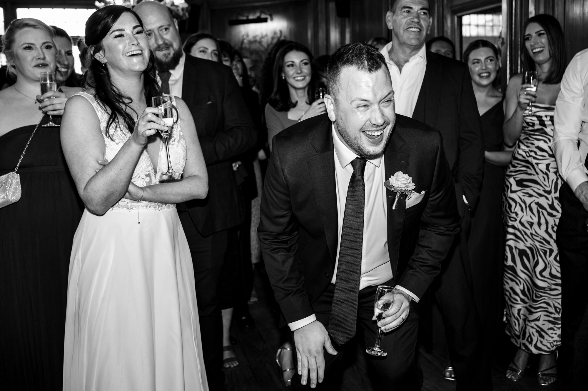 Groom and bride laugh during standing speeches in St Albans pub wedding reception