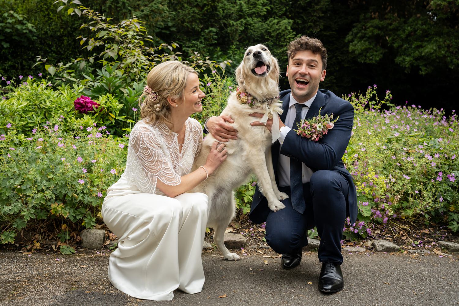 Bride and groom meet up with dog for photos at Hertford Castle grounds