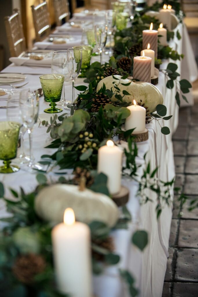 Pumpkin wedding table decorations with sage green and white tones at Coltsfoot wedding venue Hertfordshire