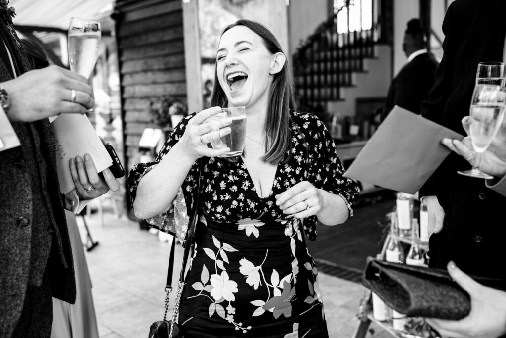 Guest laughing while driving hot apple cider at Coltsfoot wedding venue Hertfordshire