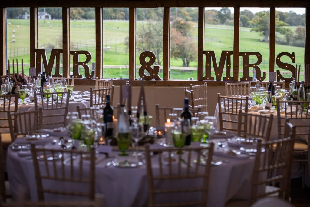 Mr & Mrs sign in windows overlooking countryside at Coltsfoot wedding venue Hertfordshire