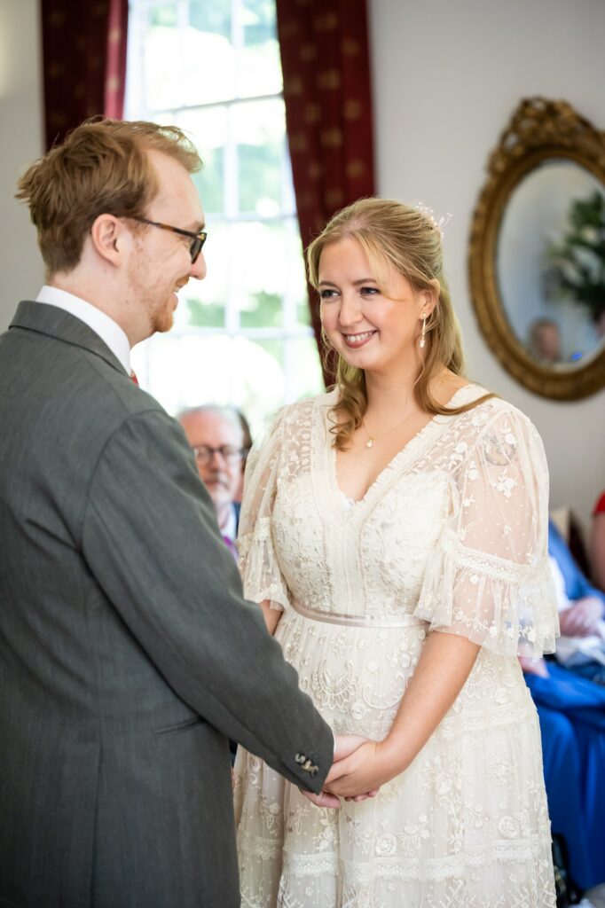Bride smiles at groom during Hertford Register office intimate wedding