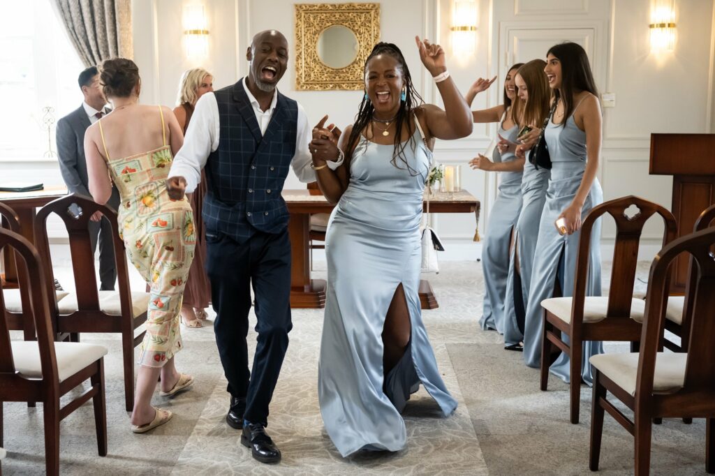 Best man and maid of honour dance out of fun St Albans Registry Office wedding ceremony