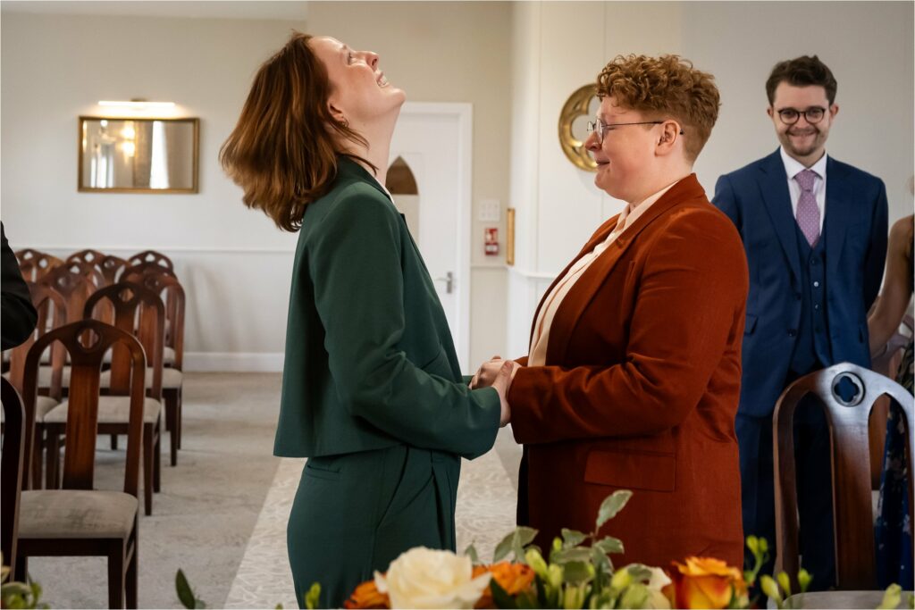 Two emotional brides try to hold back tears during wedding ceremony in St Albans.