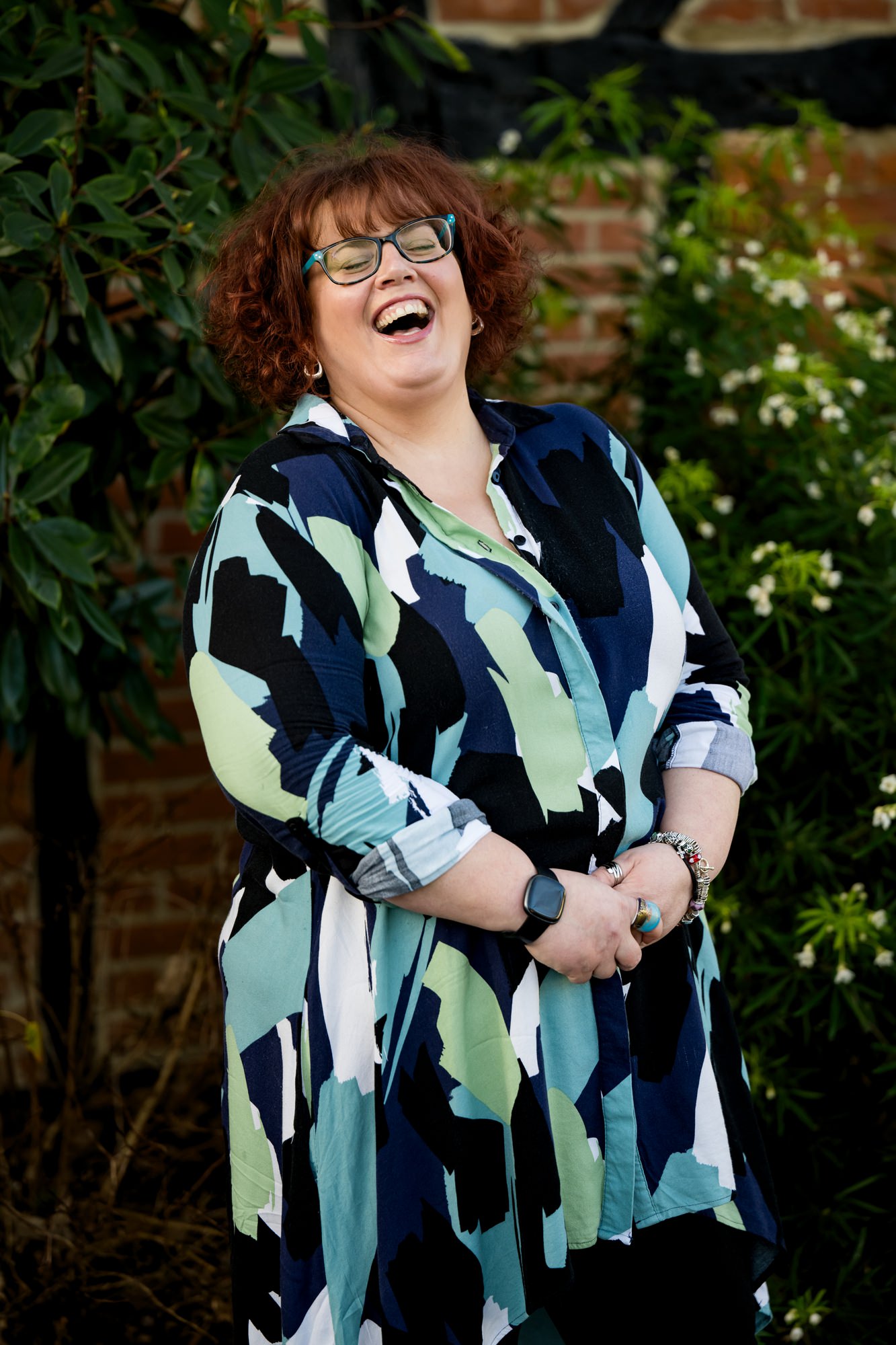 Hertfordshire business woman laughing in front of greenery
