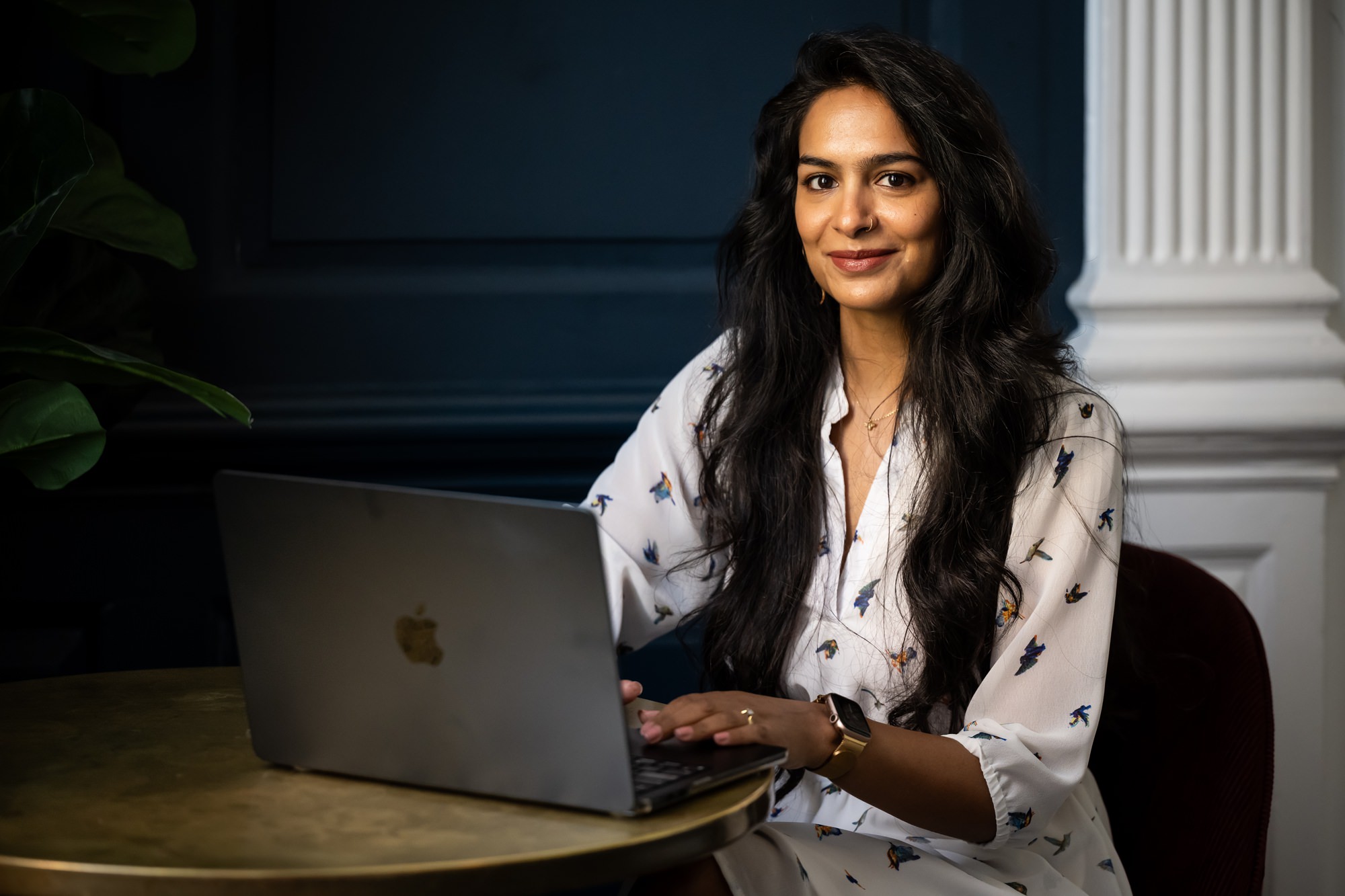 London business woman works on computer in conference room on branding shoot